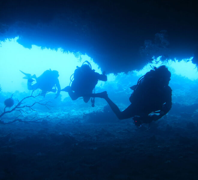 Divers in Coral Sea Caves