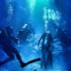 Divers Explore Underwater Cavern